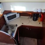Jeanneau Prestige 36 - View into the galley with gas hob, microwave, fridge and sink